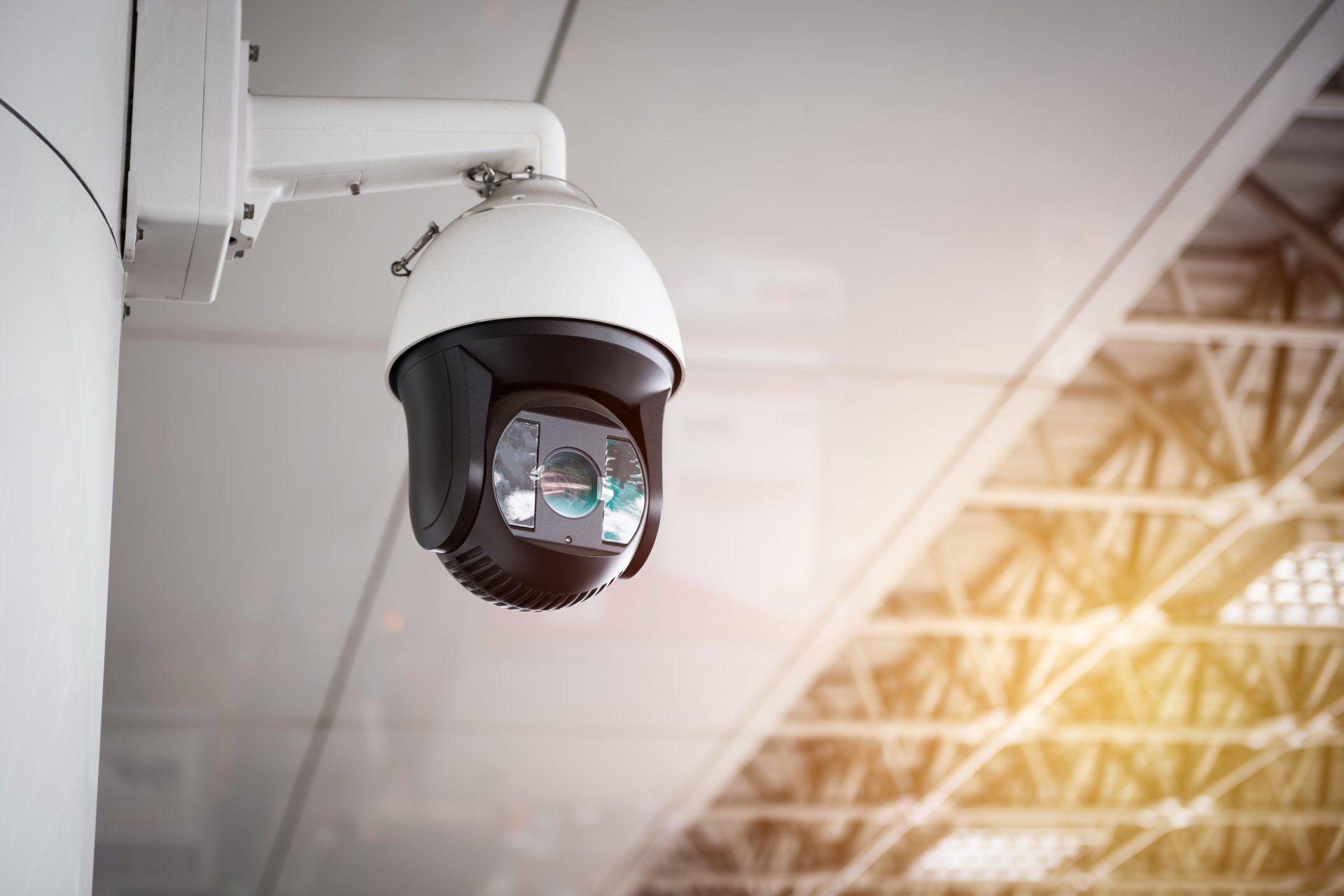 stock photo of cctv camera hanging from roof